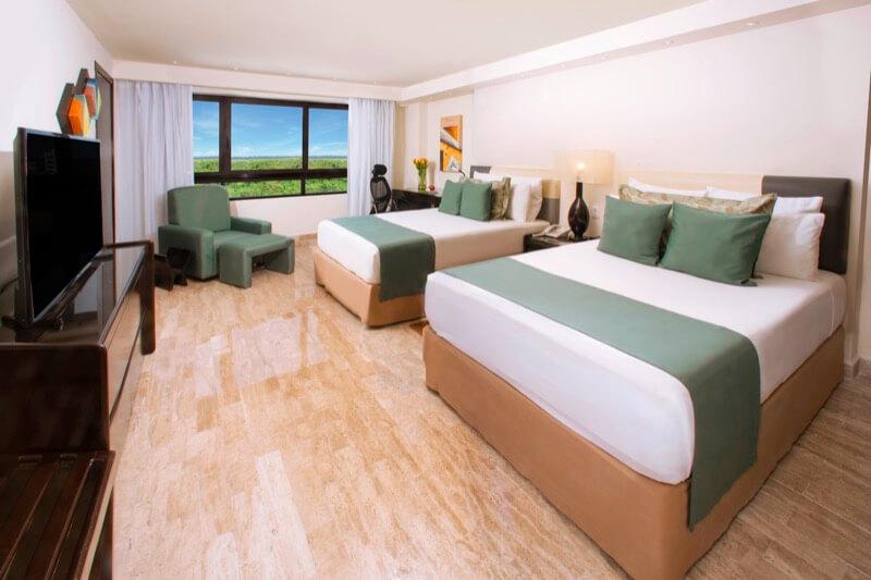 Habitación Superior con cama King Size y ventana con hermosa vista en hotel Smart Cancún by Oasis
